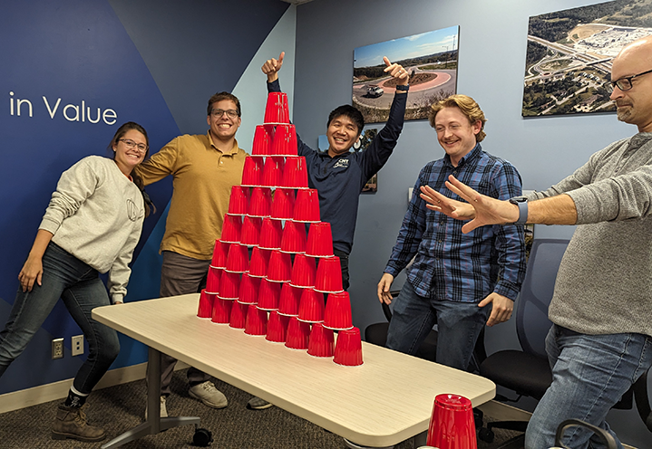 Columbus, OH, team posing with pride in front of their completed cup tower