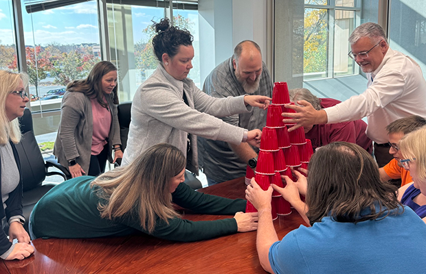 A team in Springfield, IL, stacking cups for innovation day group activity